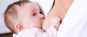 Close-up portrait of breastfeeding for little newborn baby - indoors